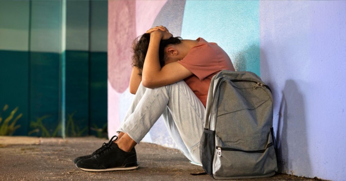 sad boy sitting on ground